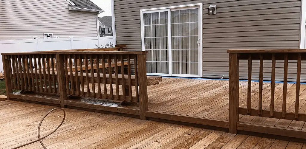 Deck sealing service protecting a backyard wood deck and railings in Chattanooga, TN