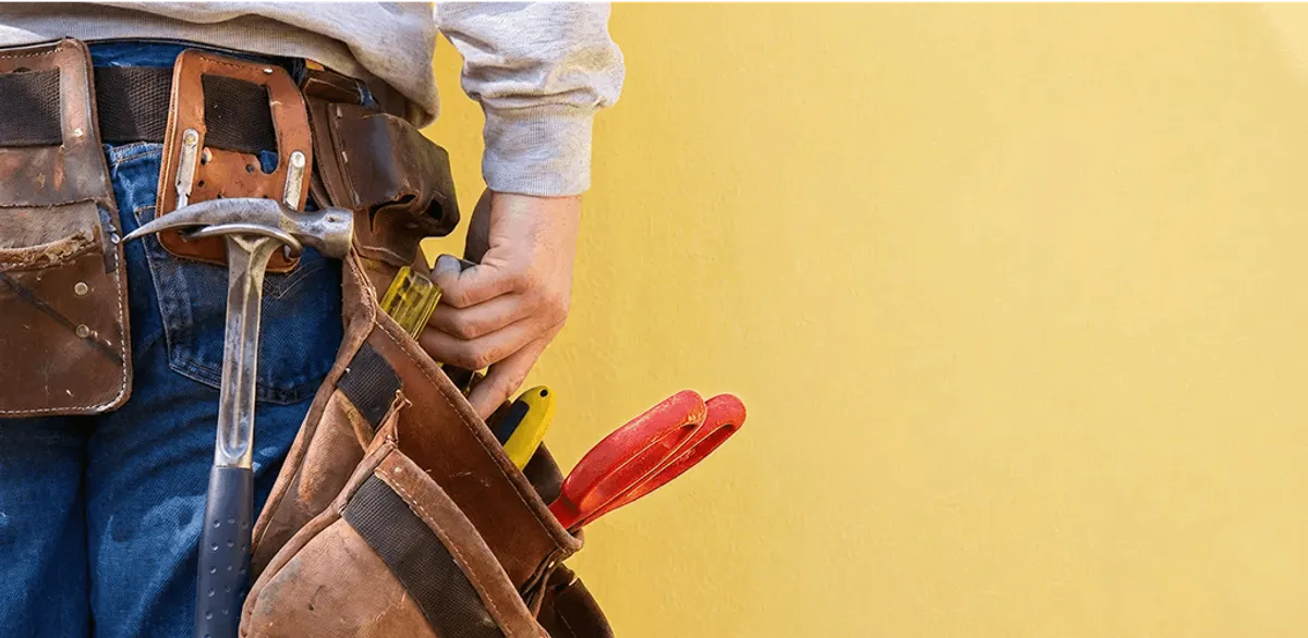 Handyman with tool belt ready for home repairs and maintenance in Chattanooga, TN