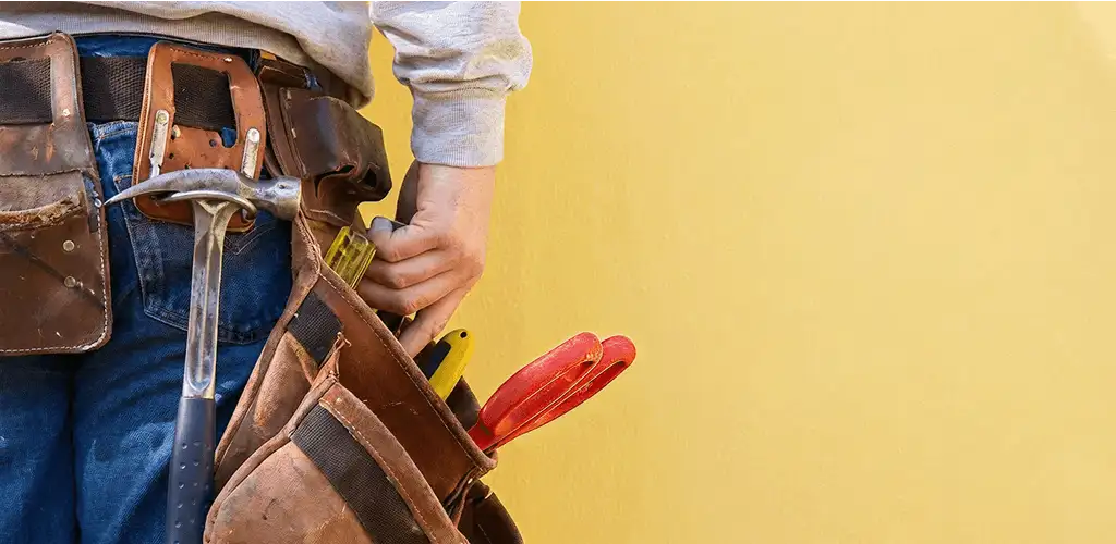 Handyman with tool belt ready for home repairs and maintenance in Chattanooga, TN