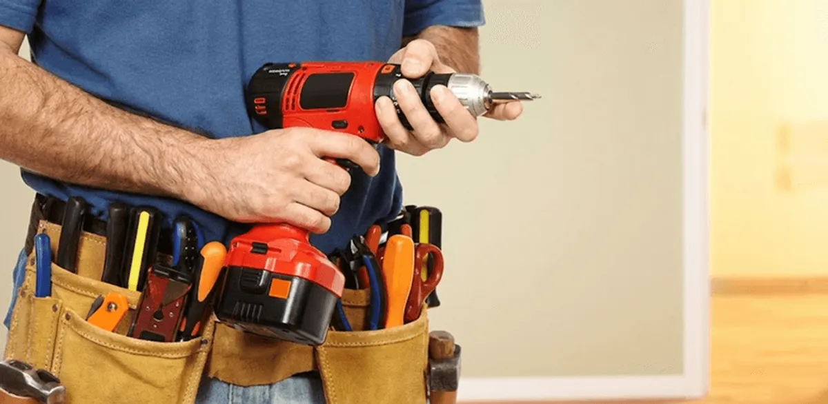 Handyman holding a power drill for home repairs and installations in Chattanooga, TN