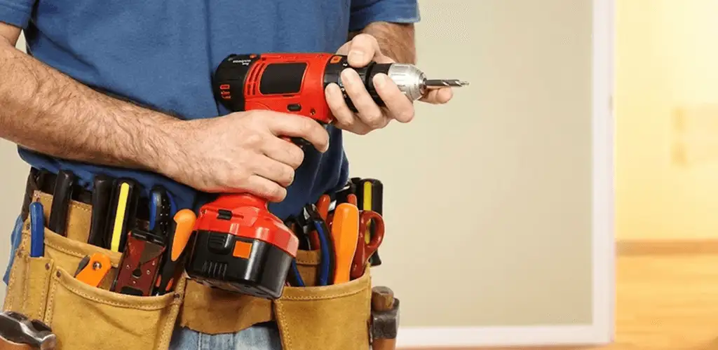Handyman holding a power drill for home repairs and installations in Chattanooga, TN