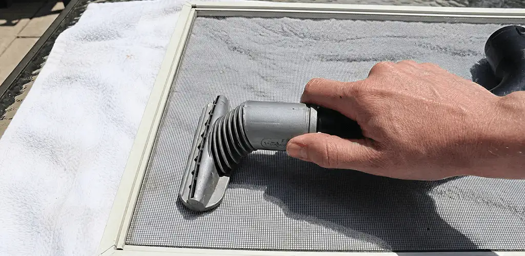 Window screen repair cleaning and fixing a damaged screen mesh in Chattanooga, TN